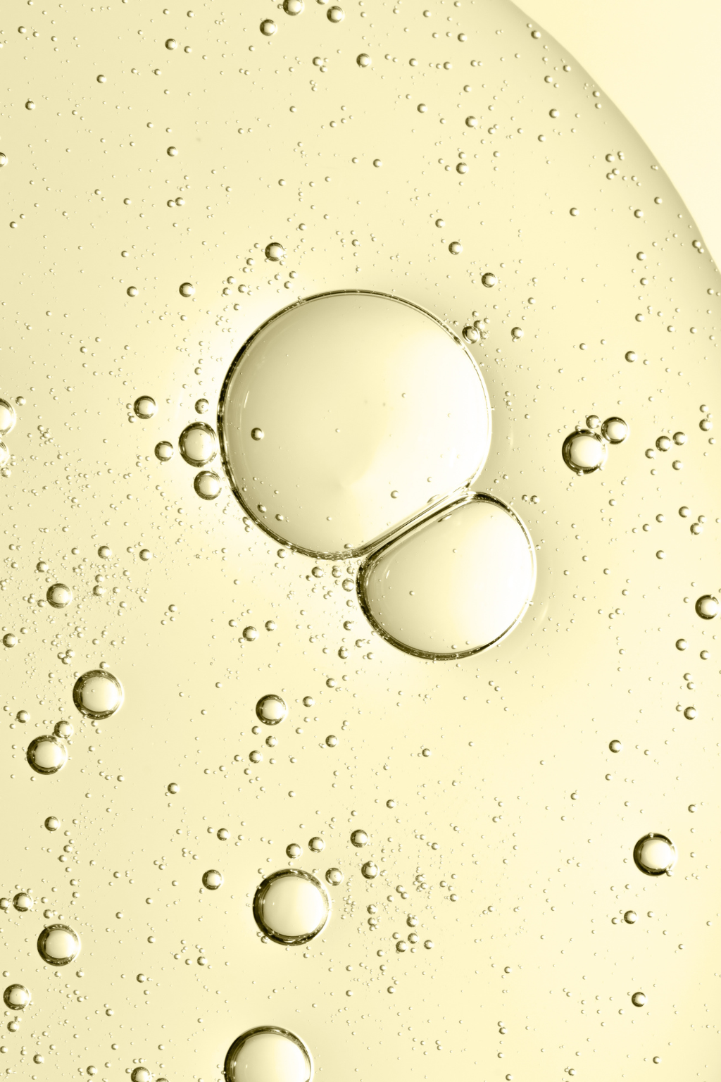 Close-up of oil droplets on a yellow background